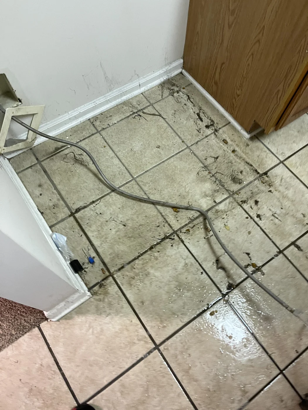 Floor with damaged flooring pulled up and debris after water damage